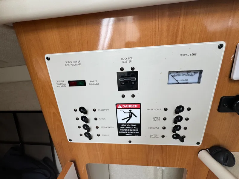 Slide: The Image of Control panel of a 2002 Bayliner 2455 Ciera boat, featuring switches and voltage meter. - 35