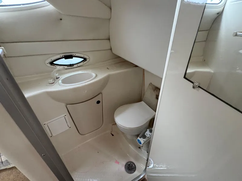 Slide: The Image of 2002 Bayliner 2455 Ciera boat bathroom with sink, toilet, and small window. - 38