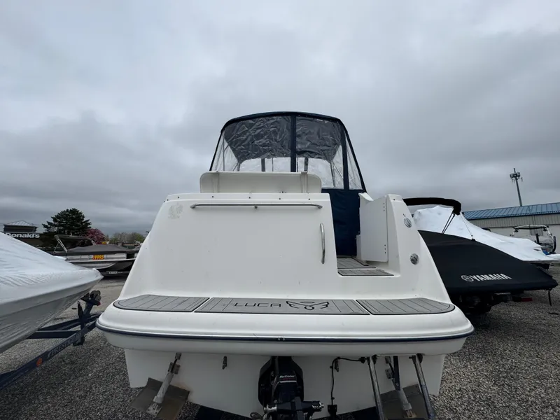 Slide: The Image of 2002 Bayliner 2455 Ciera boat, rear view, docked outdoors under cloudy skies. - 41