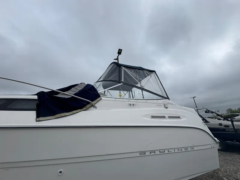 Slide: The Image of 2002 Bayliner 2455 Ciera boat with canopy under cloudy sky. - 43