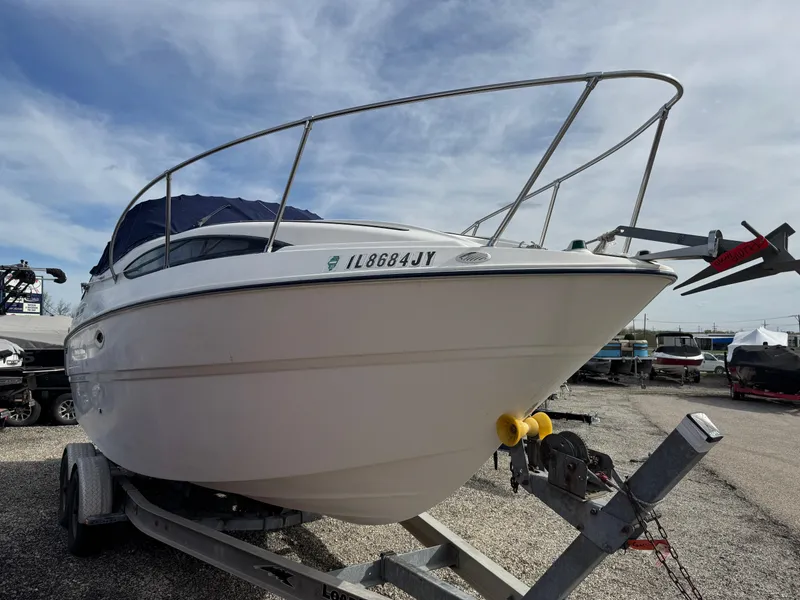 Slide: The Image of 2002 Bayliner 2455 Ciera boat on trailer, parked outdoors under cloudy sky. - 7