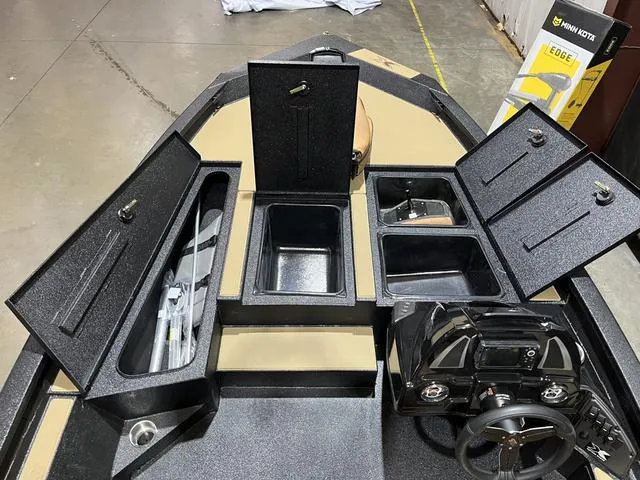 Slide: The Image of 2025 Xpress Hyper-Lift Bass H18 boat interior with storage compartments and steering wheel. - 13