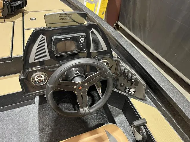 Slide: The Image of 2025 Xpress Hyper-Lift Bass H18 dashboard with steering wheel and control panel. - 15