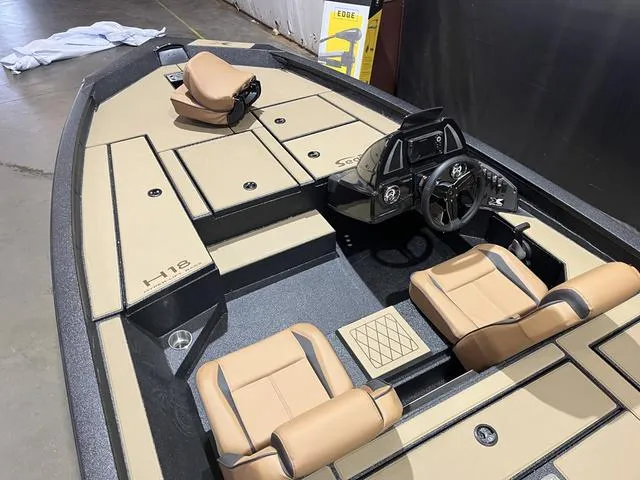 Slide: The Image of 2025 Xpress Hyper-Lift Bass H18 boat interior with Yamaha 115 "SHO" engine, tan seating. - 9