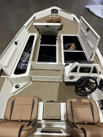 Slide: The Image of 2025 Xpress Hyper-Lift Bass H20 boat interior with storage compartments and seating. - 13