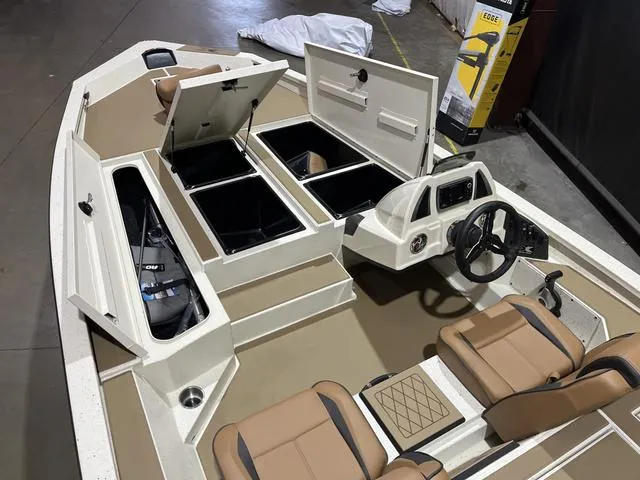 Slide: The Image of 2025 Xpress Hyper-Lift Bass H20 boat interior with storage compartments and seating. - 14
