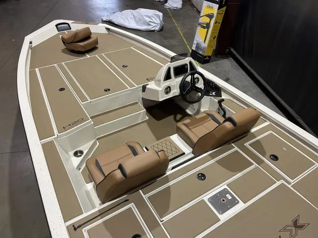 Slide: The Image of 2025 Xpress Hyper-Lift Bass H20 boat interior with Yamaha 175 "SHO" engine, tan seating. - 7