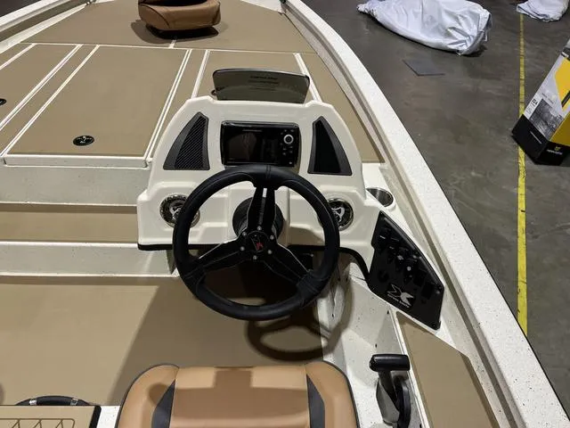 Slide: The Image of 2025 Xpress Hyper-Lift Bass H20 boat interior with steering wheel and control panel. - 9