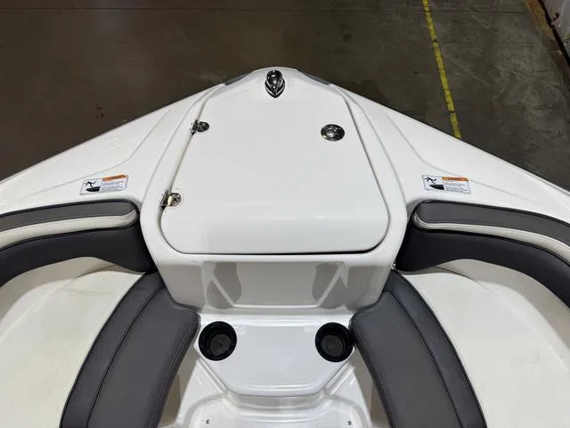 Slide: The Image of 2020 Yamaha AR210 boat interior with white and gray seating, storage compartment. - 13