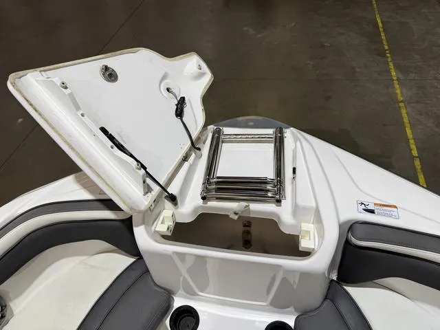 Slide: The Image of 2020 Yamaha AR210 boat with open storage compartment and ladder. - 14