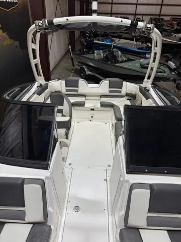 Slide: The Image of 2020 Yamaha AR210 boat interior with seating and windshield in a showroom. - 15