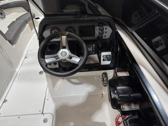 Slide: The Image of 2020 Yamaha Boats AR210 cockpit with steering wheel and control panel. - 19