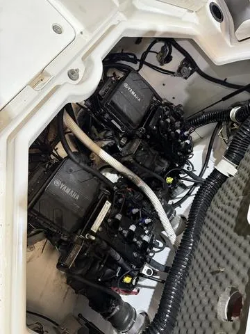 Slide: The Image of 2020 Yamaha AR210 boat engine compartment with dual engines and wiring. - 22