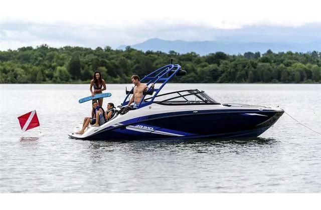 Slide: The Image of 2020 Yamaha AR210 boat with people enjoying water activities on a lake. - 27
