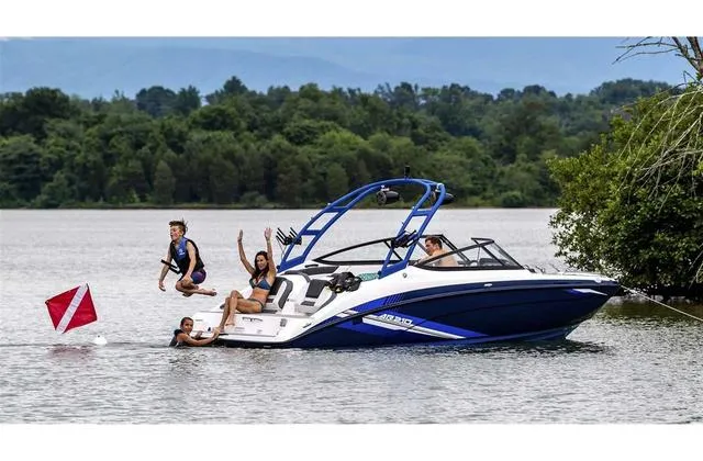 Slide: The Image of 2020 Yamaha AR210 boat with people enjoying water activities on a lake. - 31
