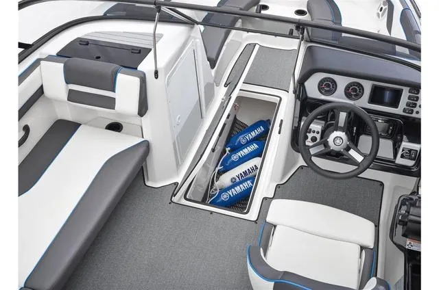 Slide: The Image of 2020 Yamaha AR210 boat interior with storage compartment and steering console. - 32