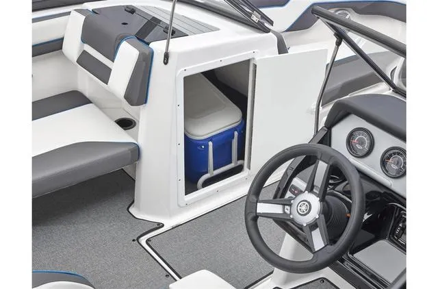 Slide: The Image of 2020 Yamaha AR210 boat interior with steering wheel, seating, and storage compartment. - 34