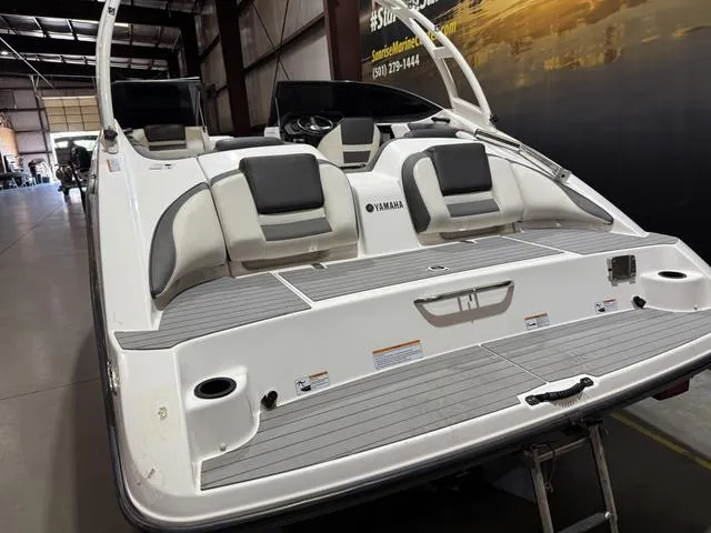 Slide: The Image of 2020 Yamaha AR210 boat interior with seating, displayed in a showroom. - 6