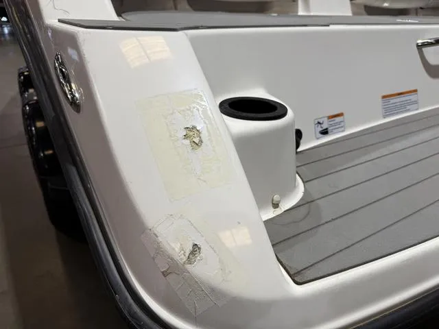 Slide: The Image of 2020 Yamaha AR210 boat with visible surface damage near cup holder. - 7