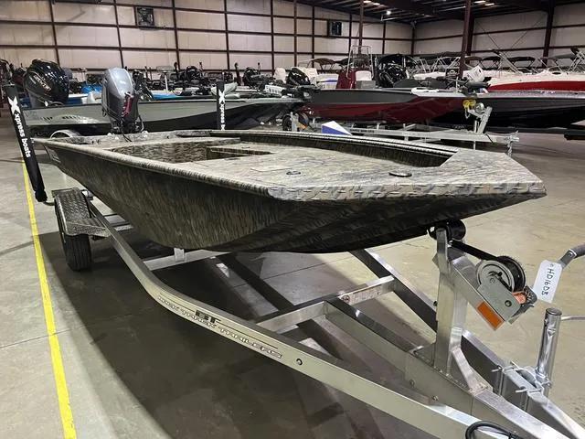 Slide: The Image of 2025 Xpress HD16DB boat with Yamaha 50 engine on trailer in warehouse. - 4