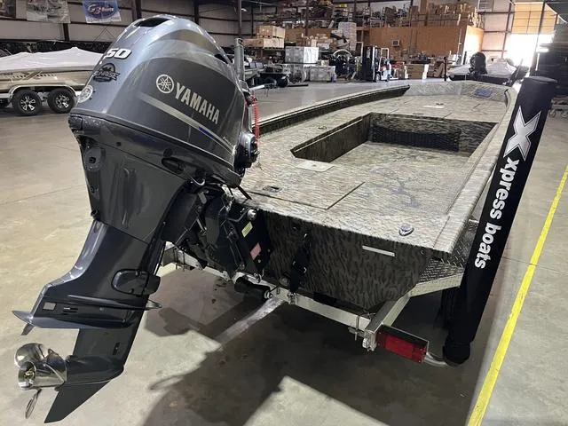 Slide: The Image of 2025 Xpress HD16DB boat with Yamaha 50 engine in warehouse setting. - 5