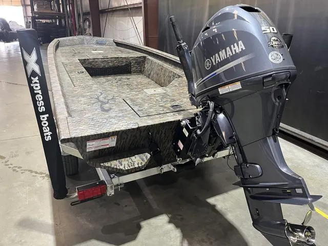 Slide: The Image of 2025 Xpress HD16DB boat with Yamaha 50 engine in a garage setting. - 6