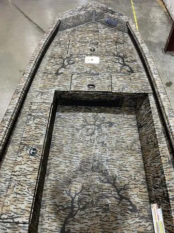 Slide: The Image of 2025 Xpress HD16DB boat interior with camouflage design and storage compartments. - 7