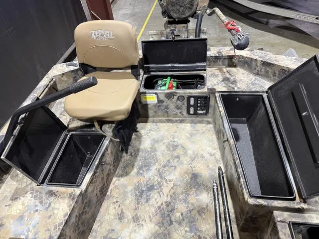 Slide: The Image of 2023 Excel Shallow Water F4 boat interior with storage compartments and seating. - 11