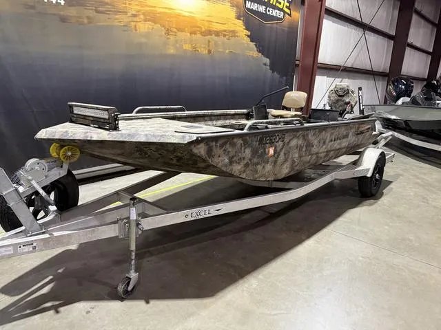 Slide: The Image of 2023 Excel Shallow Water F4 1860 boat with Mud Buddy 40HDR, on trailer in showroom. - 2