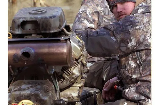 Slide: The Image of Man in camouflage operating Excel Shallow Water F4 1860 boat with Mud Buddy 40HDR engine. - 27