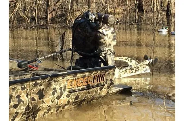 Slide: The Image of 2023 Excel Shallow Water F4 1860 boat with Mud Buddy 40HDR in a wooded, flooded area. - 28