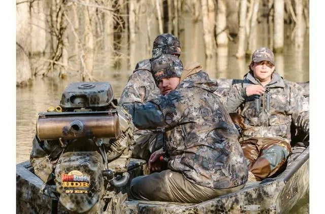 Slide: The Image of Men in camo gear on 2023 Excel Shallow Water F4 boat in wooded waterway. - 29