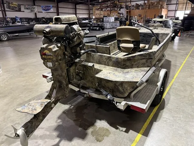 Slide: The Image of 2023 Excel Shallow Water F4 boat with Mud Buddy 40HDR engine in a warehouse. - 4