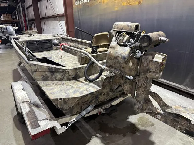 Slide: The Image of 2023 Excel Shallow Water F4 boat with Mud Buddy 40HDR engine in a warehouse. - 5