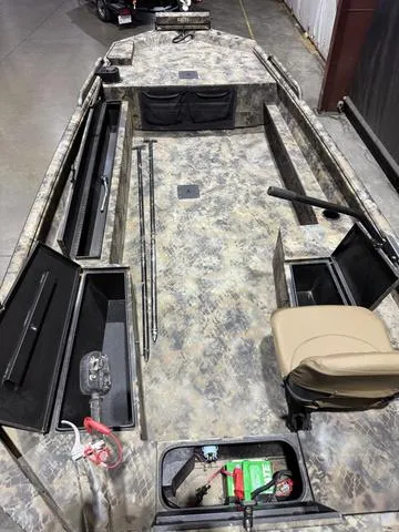 Slide: The Image of 2023 Excel Shallow Water F4 boat with Mud Buddy 40HDR, camo design, interior view. - 6