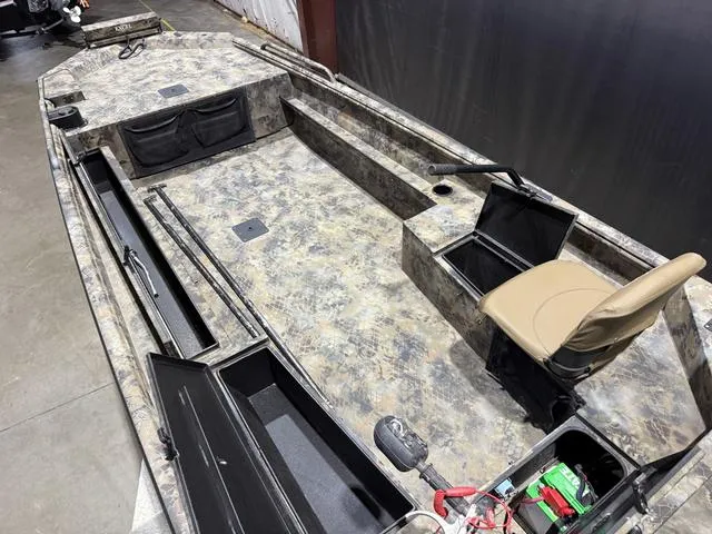 Slide: The Image of 2023 Excel Shallow Water F4 1860 boat interior with camo design and storage compartments. - 7