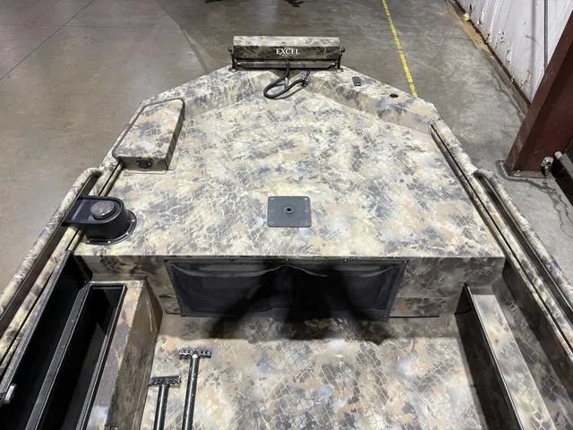 Slide: The Image of 2023 Excel Shallow Water F4 boat interior with camouflage design and storage compartments. - 8