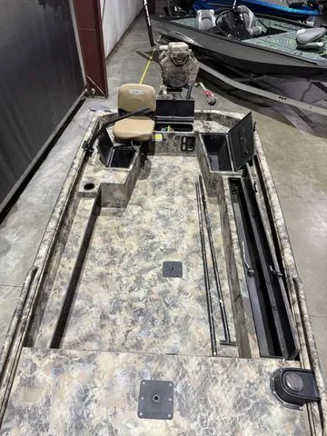 Slide: The Image of 2023 Excel Shallow Water F4 1860 boat with Mud Buddy 40HDR, camo design, interior view. - 9