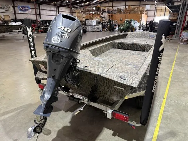 Slide: The Image of 2024 Xpress HD15DBX boat with Yamaha 40HP engine in a warehouse setting. - 4