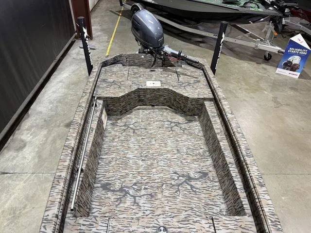 Slide: The Image of 2024 Xpress HD15DBX boat with Yamaha 40HP engine, camo interior, displayed indoors. - 7