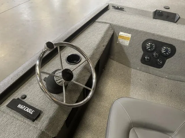 Slide: The Image of 2025 War Eagle 754VS boat interior with steering wheel and control panel. - 7