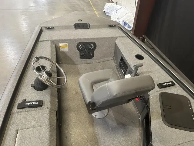 Slide: The Image of 2025 War Eagle 754VS boat interior with steering wheel and seat, featuring Yamaha 50 engine. - 8