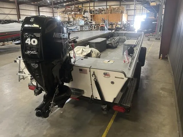 Slide: The Image of 2024 Supreme L61 boat with Mercury 60/40 Jet engine in a warehouse setting. - 4