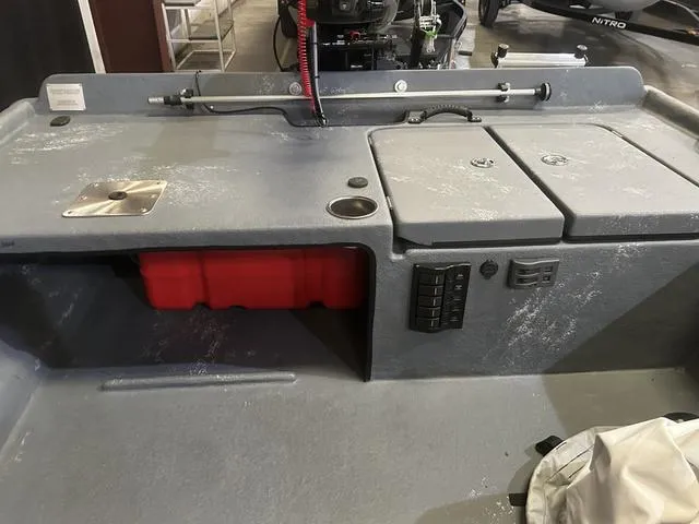 Slide: The Image of 2024 Supreme L61 boat interior with storage compartments and control panel. - 9