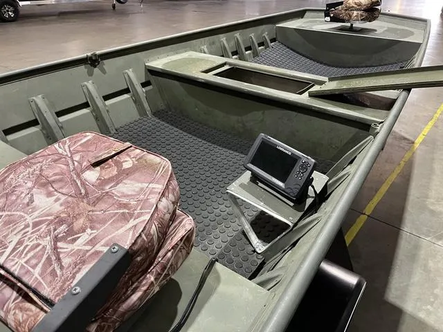 Slide: The Image of 2015 Alumacraft 1648 boat interior with camo seats and a mounted fish finder. - 10