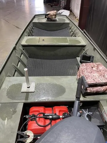 Slide: The Image of 2015 Alumacraft 1648 boat interior with Yamaha 25 engine, featuring seating and storage. - 7