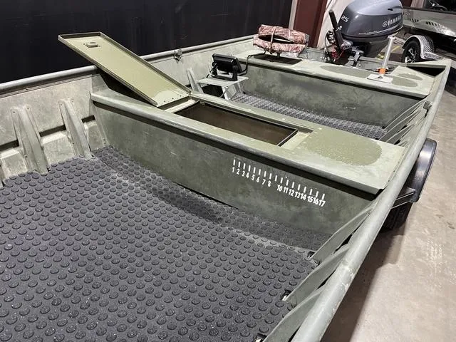 Slide: The Image of 2015 Alumacraft 1648 boat interior with Yamaha 25 engine, open storage, and measuring guide. - 9