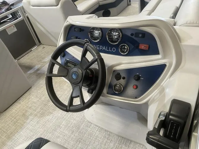 Slide: The Image of 2023 Nepallo Pontoons 20 TL dashboard with Suzuki 90 controls, featuring steering wheel and gauges. - 11