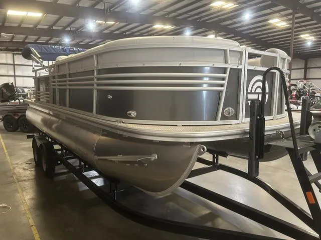Slide: The Image of 2023 Nepallo Pontoons 20 TL with Suzuki 90, displayed indoors on a trailer. - 2