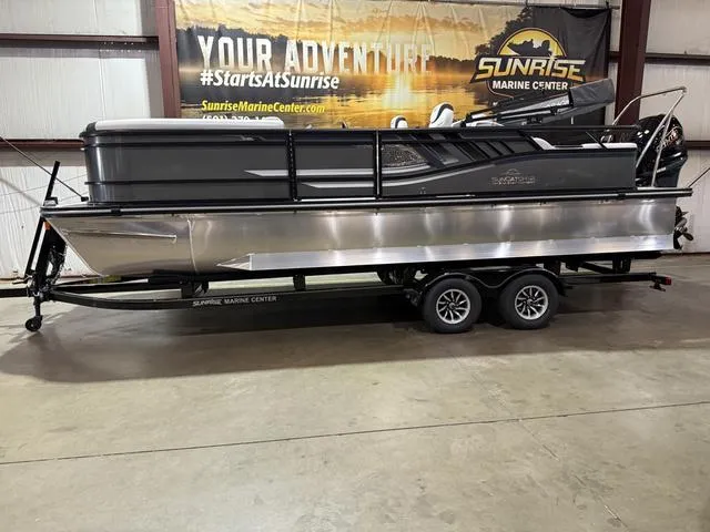 Slide: The Image of 2025 SunCatcher Select 322SS boat cruising on a lake at sunset. - 1